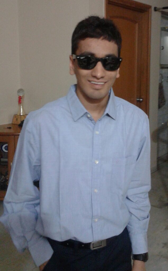 Darpan in formal clothes with specks