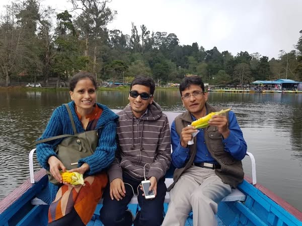 Photo of Darpan with parents on holiday